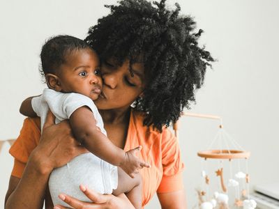 mom kissing baby
